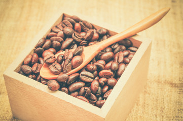 Coffee beans and wooden spoon with filter effect retro vintage s