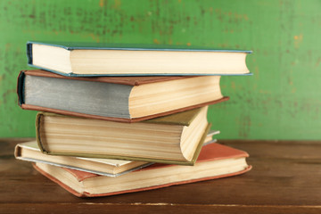 Stack of books on wooden background