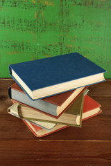 Stack of books on wooden background