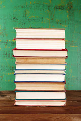 Stack of books on wooden background