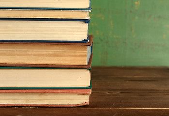 Stack of books on wooden background