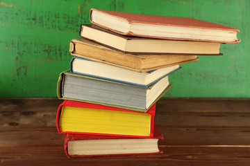 Stack of books on wooden background