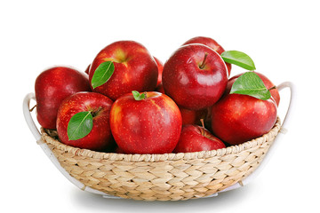 Ripe red apple in wicker basket isolated on white