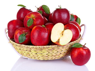Ripe red apple in wicker basket isolated on white