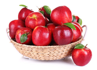 Ripe red apple in wicker basket isolated on white