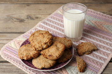 Homemade cookies and glass of milk on table close up