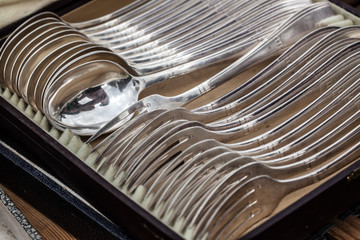 display of old silverware, silver forks and spoons in their box for collection sold at flea market...
