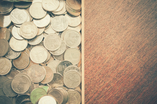 coins on wood with filter effect retro vintage style