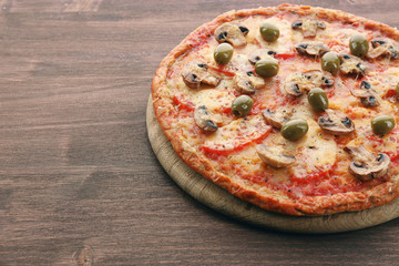 Tasty pizza with vegetables on wooden background