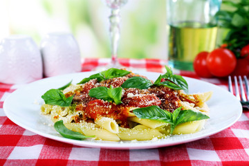 Pasta with tomato sauce on bright background