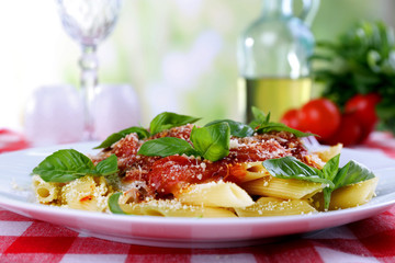 Pasta with tomato sauce on bright background