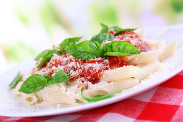 Pasta with tomato sauce on bright background