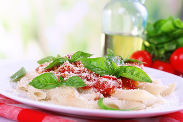 Pasta with tomato sauce on bright background