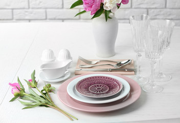 Beautiful table setting with flowers in vase close up