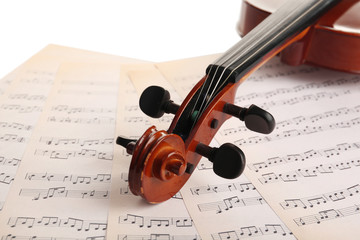 Fototapeta premium Classical violin on music sheets background