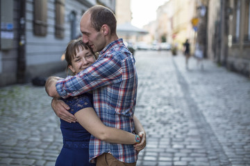 Couple in love hugging on the street. Man and woman during honeymoon..