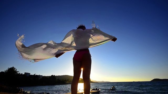 silhouette of dancing woman sith scarf on the beach wind, inspiration,FREEDOM CONCEPT