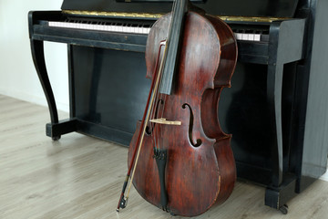 Cello near piano, indoors © Africa Studio