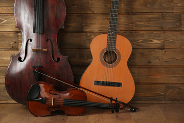 Musical instruments on wooden planks background