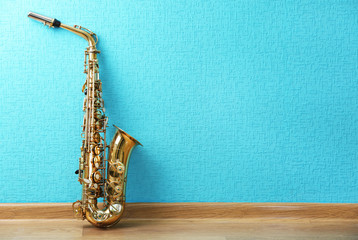 Saxophone on turquoise wallpaper background