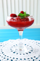 Frozen Strawberry dessert in glass, on color wooden background