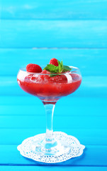 Frozen Strawberry dessert in glass, on color wooden background