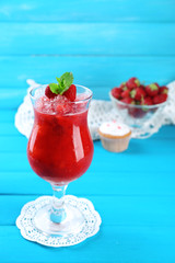 Frozen Strawberry dessert in glass, on color wooden background