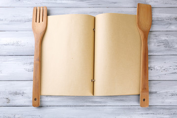 Open recipe book on wooden background