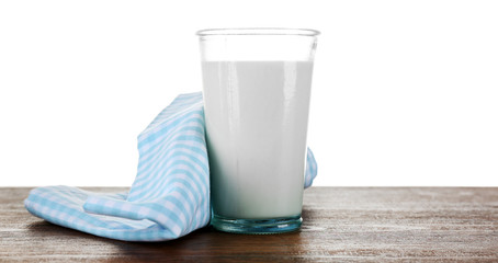 Glass of milk on wooden table, on white background
