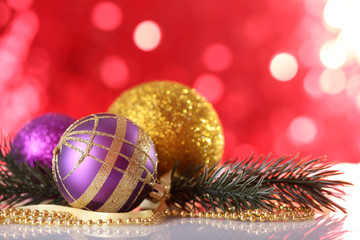 Beautiful Christmas balls on red blurred background