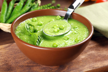 Tasty peas soup on table close up