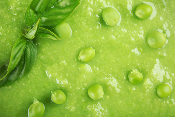 Tasty peas soup with basil close up