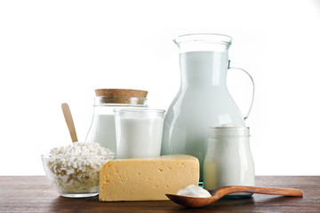 Dairy products on wooden table on white background
