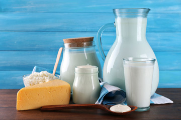 Dairy products on wooden table on blue  background