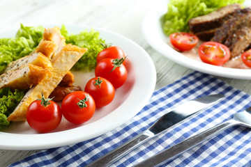 Slices of chicken fillet with spices and cherry tomato on table close up