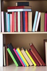 Books on wooden shelf.