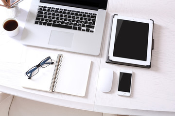 Laptop with tablet and smart phone on Workplace top view