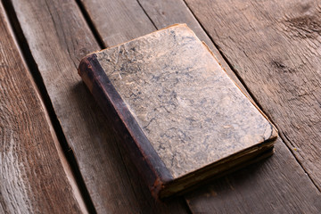 Old book on wooden table close up