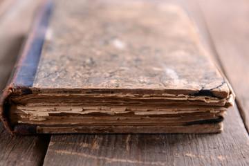 Old book on wooden table close up