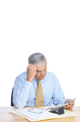 Businessman Reading Newspaper at Desk