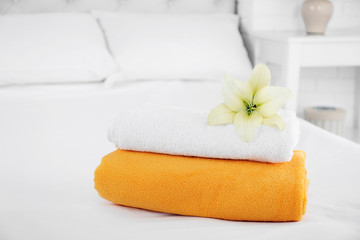 Fototapeta na wymiar Freshly laundered fluffy towels in bedroom interior