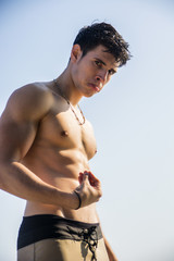 Muscular young man shirtless doing Italian gesture