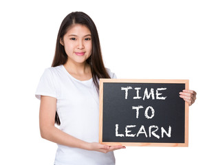 Young lady with black board and showing phrase time to learn