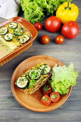 Casserole with vegetable mallow on wooden background