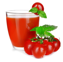 Glass of tomato juice with green leaves isolated on white