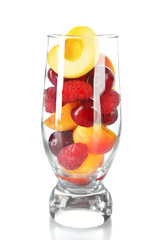 Glass of berries and fruits isolated on white