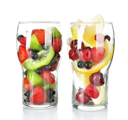 Glasses of berries and fruits isolated on white