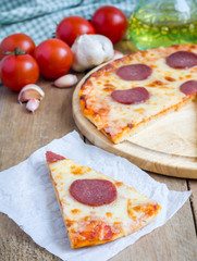 Slice of homemade pepperoni pizza, ready to eat