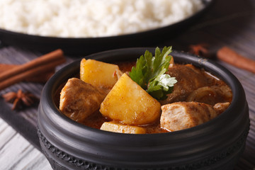 massaman curry with chicken macro in a bowl on the table. horizontal

