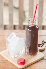 Bottle of black coffee with ice